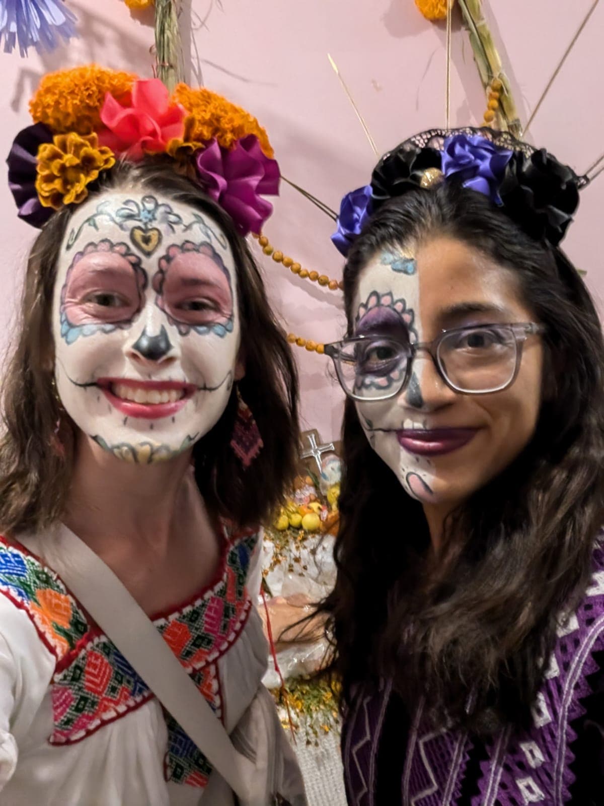 Teacher and student with traditional Catrina face paint celebrating Día de los Muertos in Oaxaca