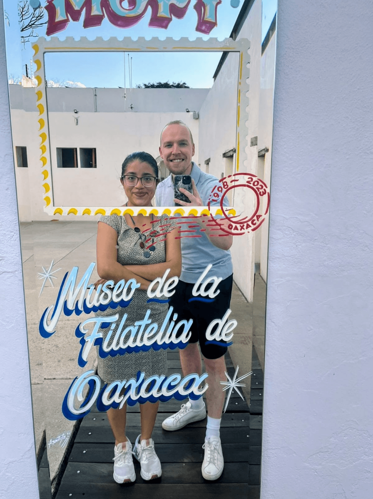 Spanish teacher and student taking a mirror selfie at the Museo de la Filatelia de Oaxaca