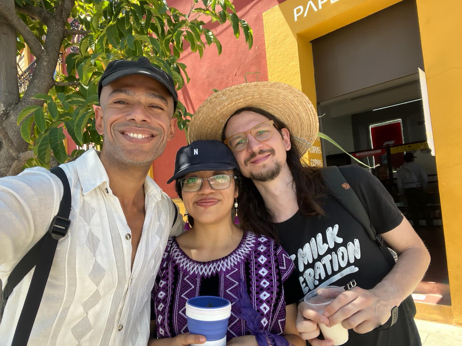 Spanish teacher and students enjoying drinks on a colorful street in Oaxaca