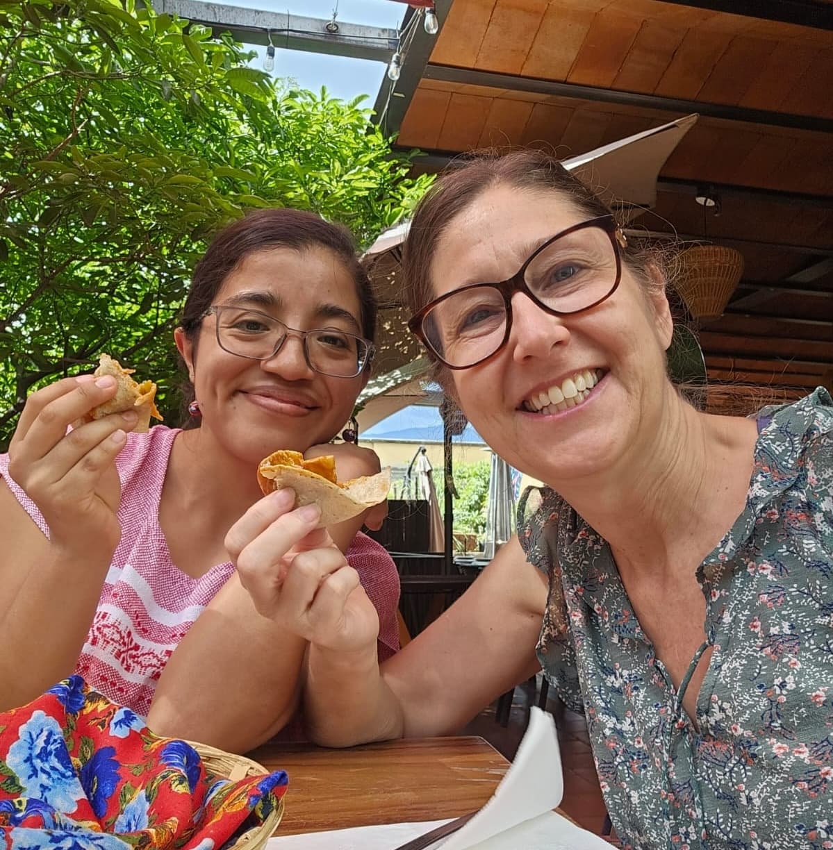 Spanish teacher and student tasting traditional Oaxacan cuisine at an outdoor restaurant
